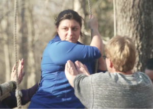 thumbnail for a military sexual trauma program video of veterans supporting each other on outdoor rope challenge course