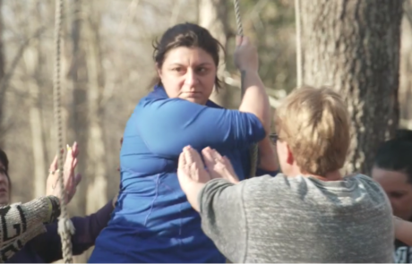 thumbnail for a military sexual trauma program video of veterans supporting each other on outdoor rope challenge course