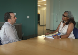 Thumbnail of a FMLA video for patients showing an employee and HR representative at an office table