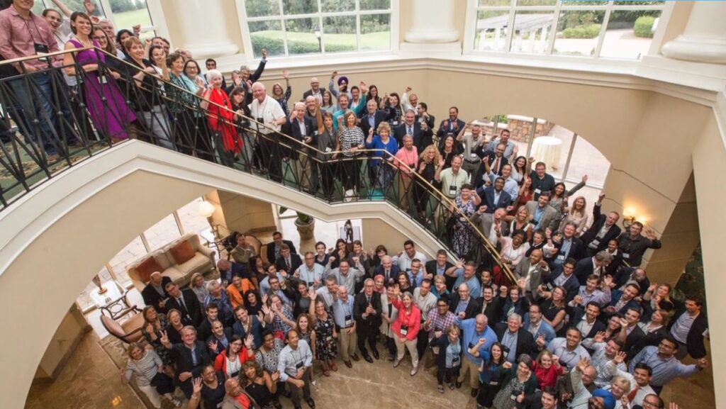 Conference attendees gathered and waving at professional event filmed by MiniMatters