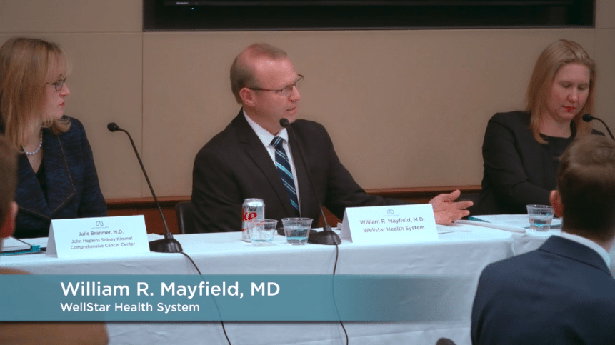 William R. Mayfield, MD from WellStar Health System is speaking at a table with two other panelists seated beside him.