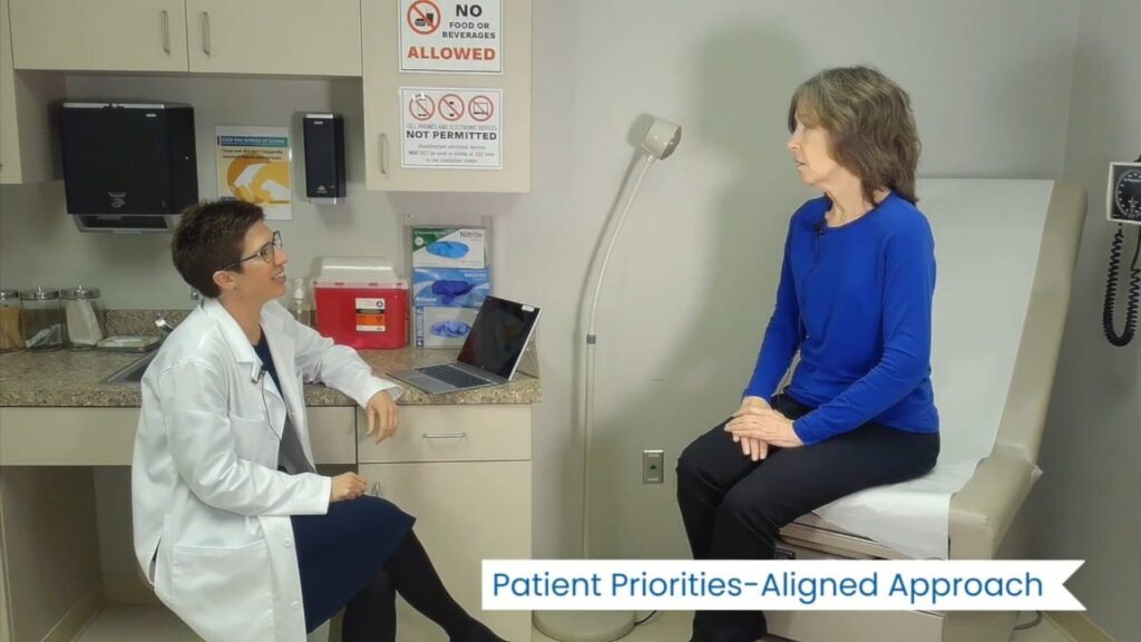 A doctors office room with a women sitting at the patients chair and talking to the doctor infront of her | training video production Washington DC