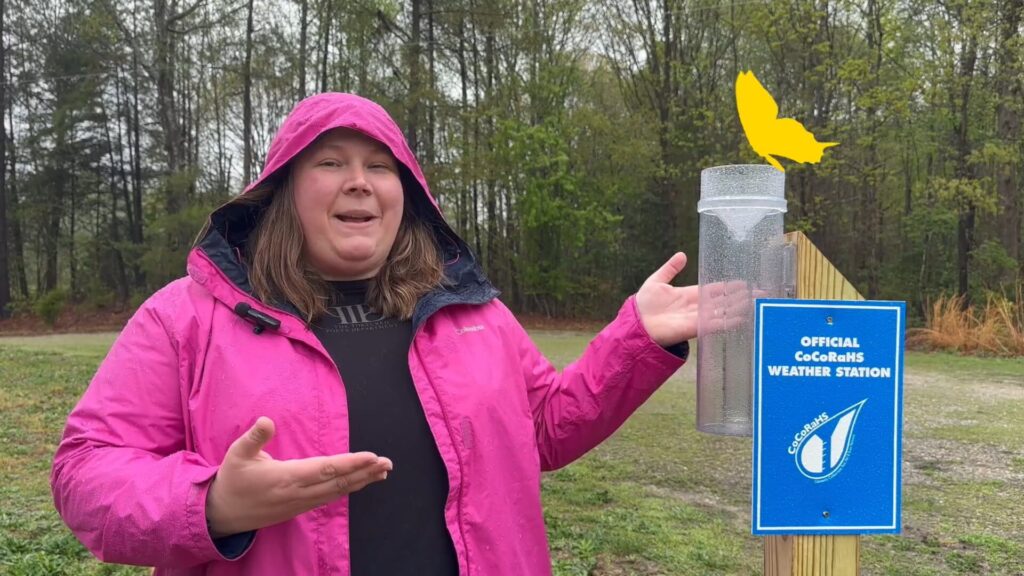 thumbnail for a master naturalist video with a volunteer in a bright pink coat next to a weather station outside in a natural area