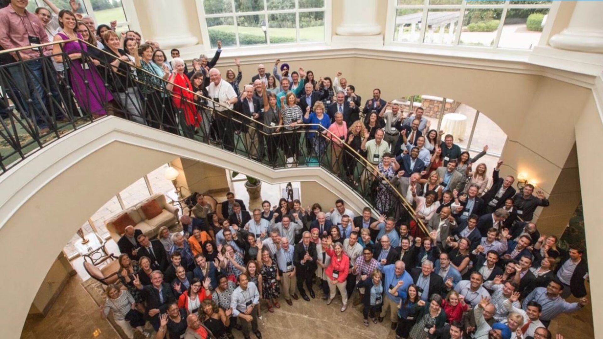 Conference attendees gathered and waving at professional event filmed by MiniMatters