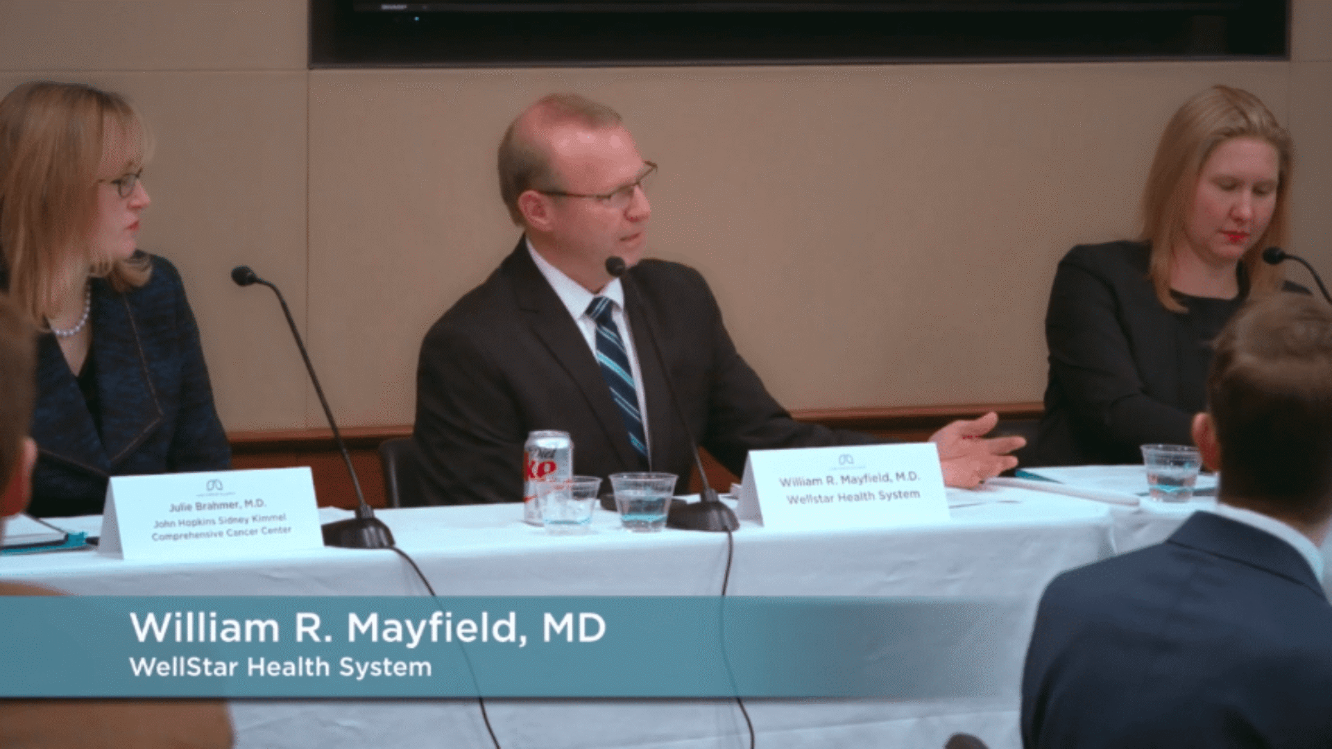 William R. Mayfield, MD from WellStar Health System is speaking at a table with two other panelists seated beside him.