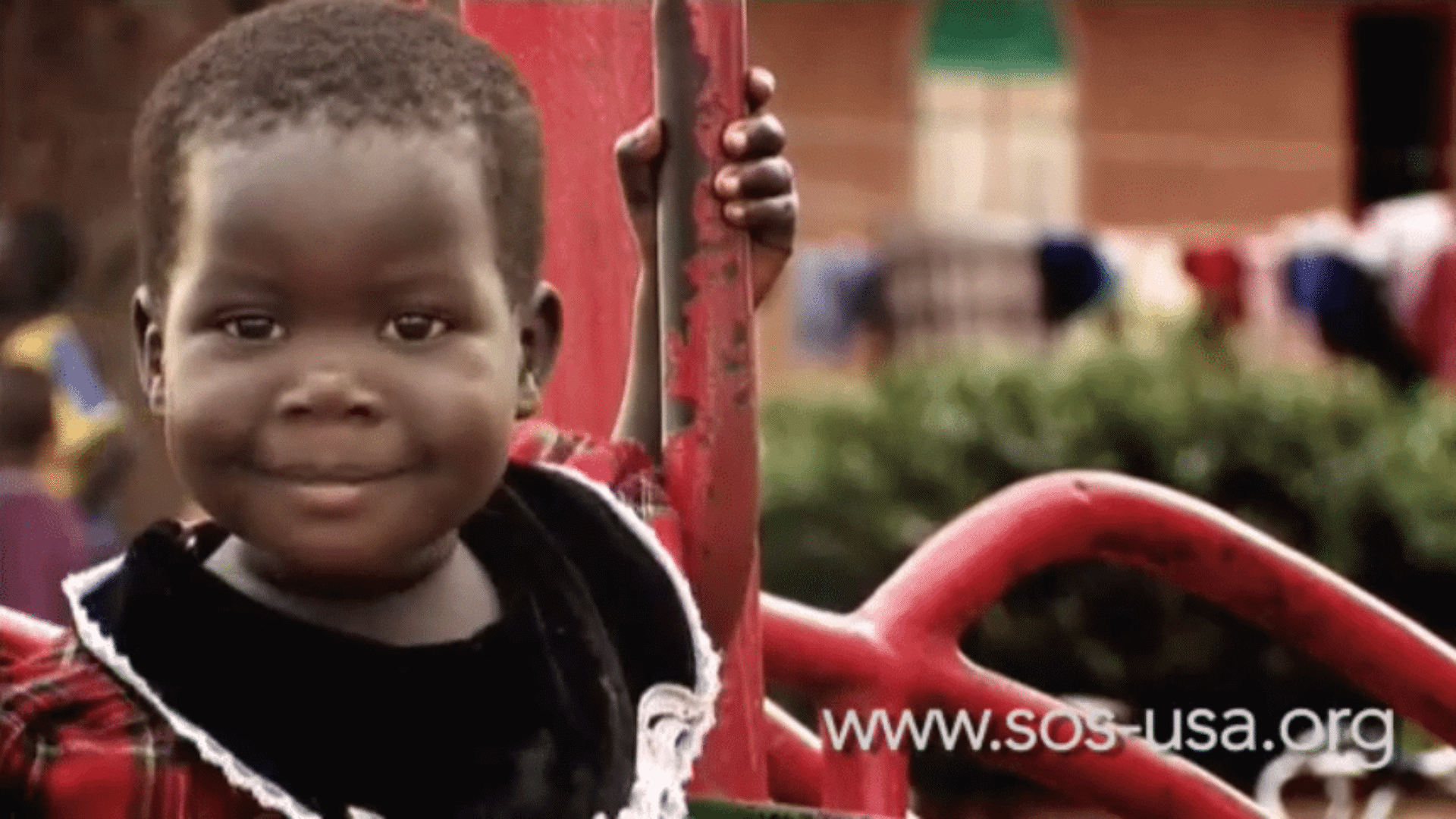 A smiling young girl featured in a nonprofit fundraising video for SOS Children's Villages USA.