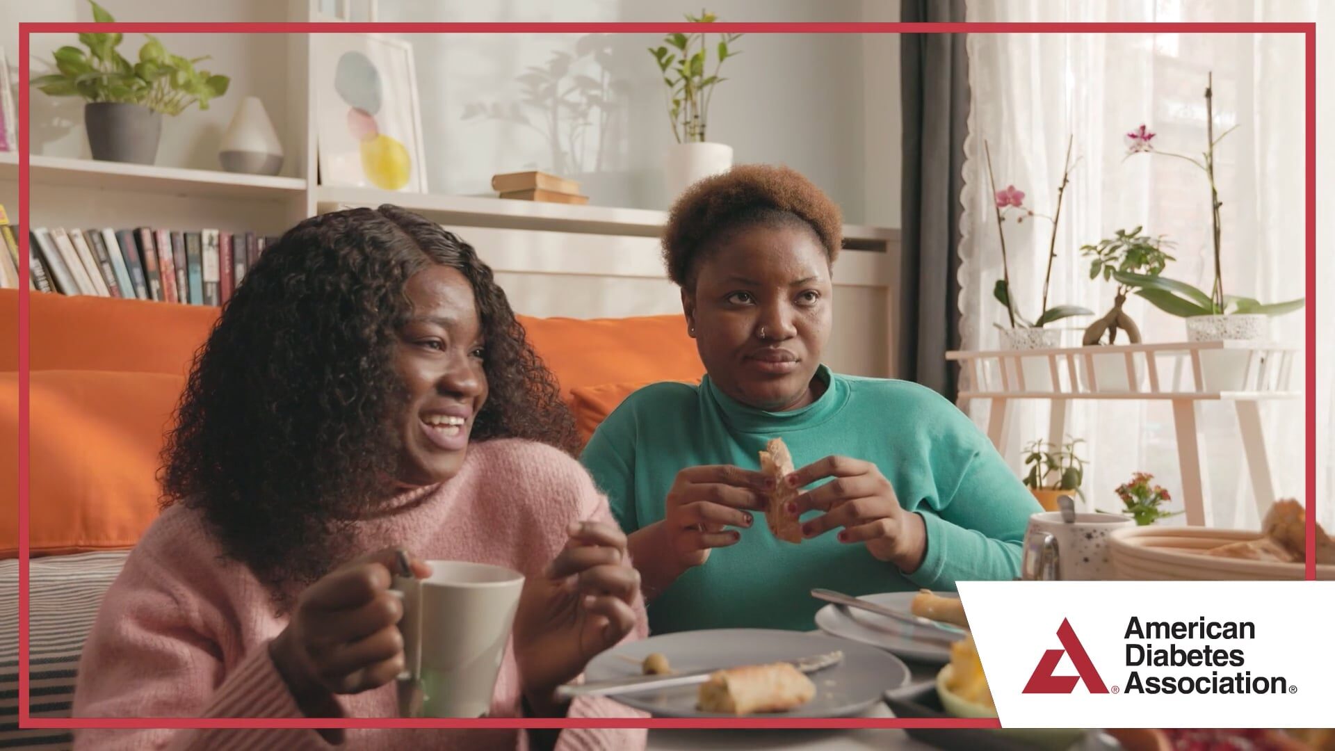 Two women eating and drinking tea at home in Spanish nutrition video