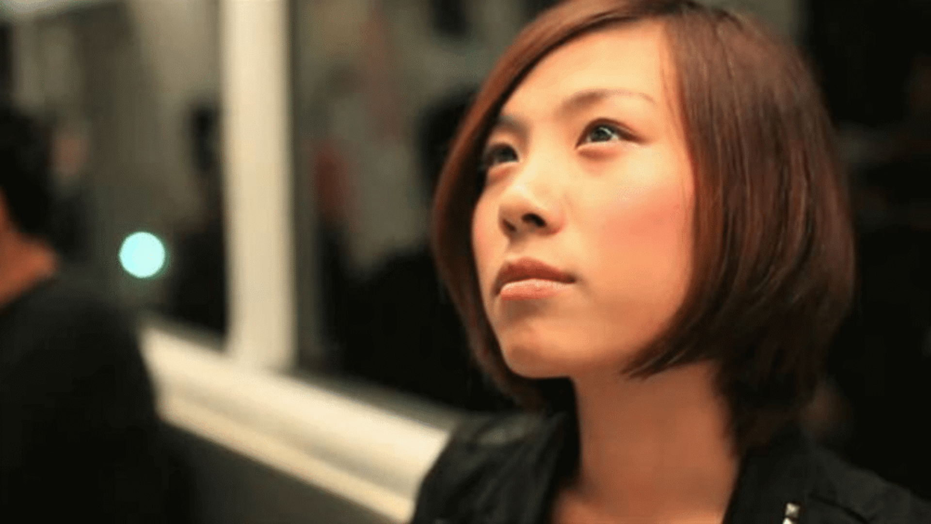 young Asian woman on subway